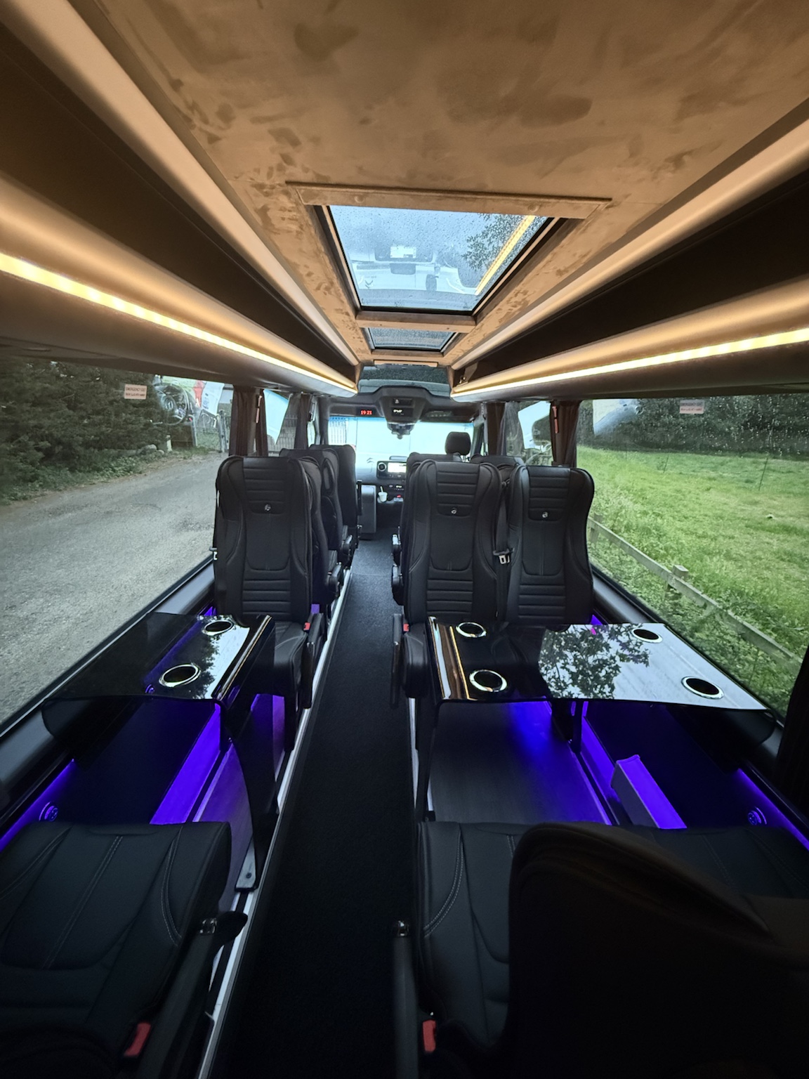 Cabin interior at dusk with warm roof lighting and purple ambient accents