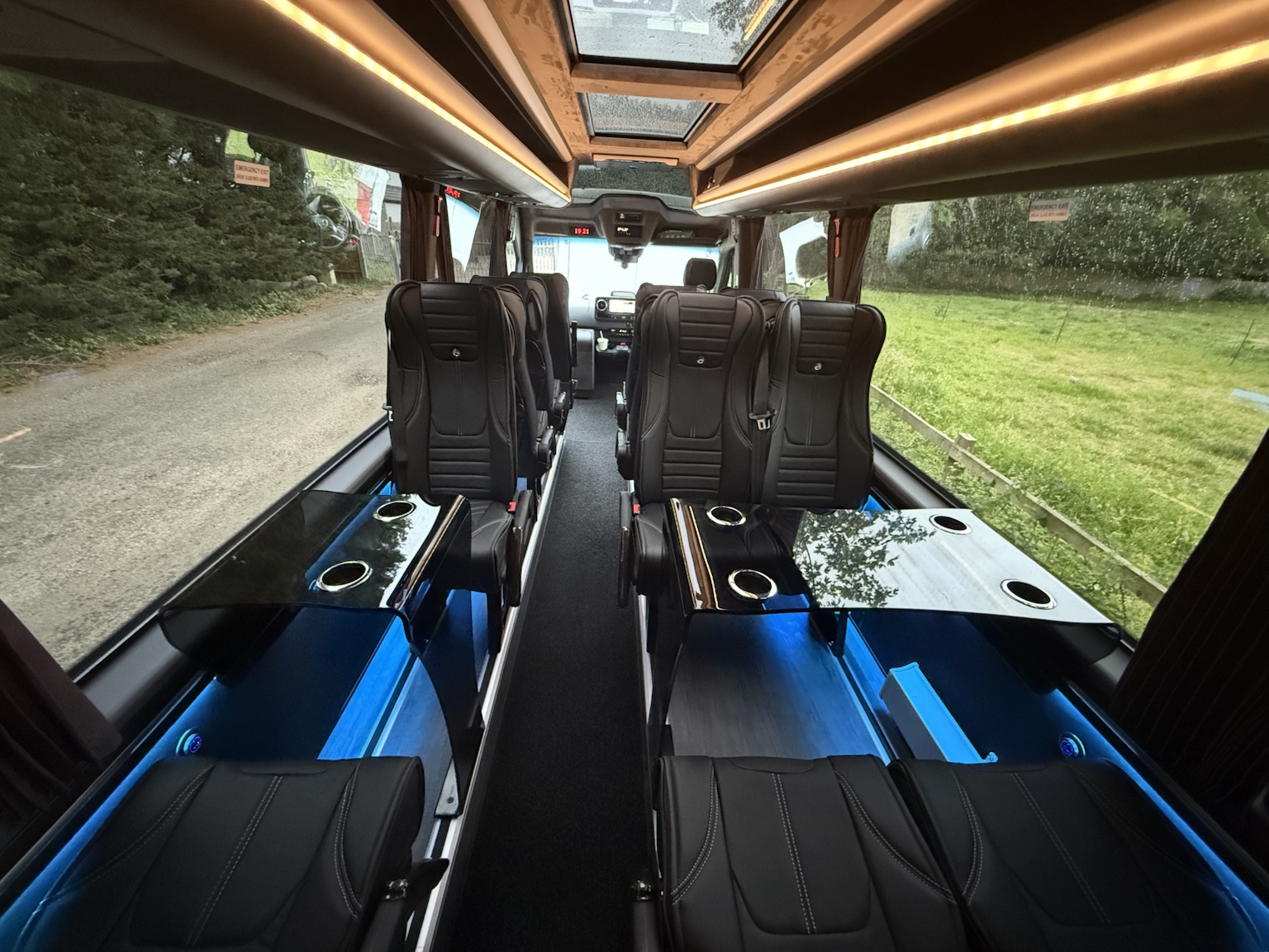Wide view of the cabin tables, cup holders and forward-facing seats