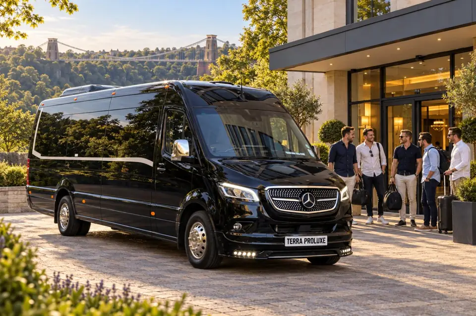 Black Mercedes-Benz Sprinter beside a group of business travellers near a modern building.
