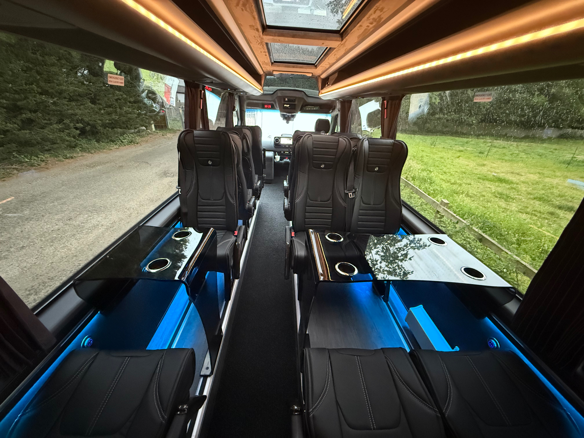 Panoramic glass roof panels above the executive minibus cabin