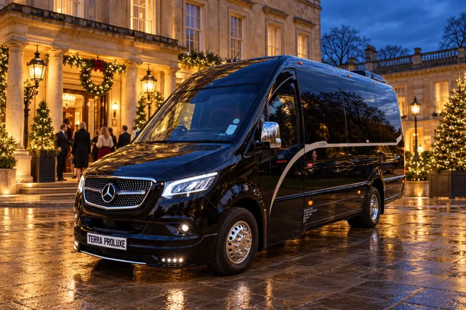 Black Mercedes-Benz Sprinter outside a venue decorated for Christmas.
