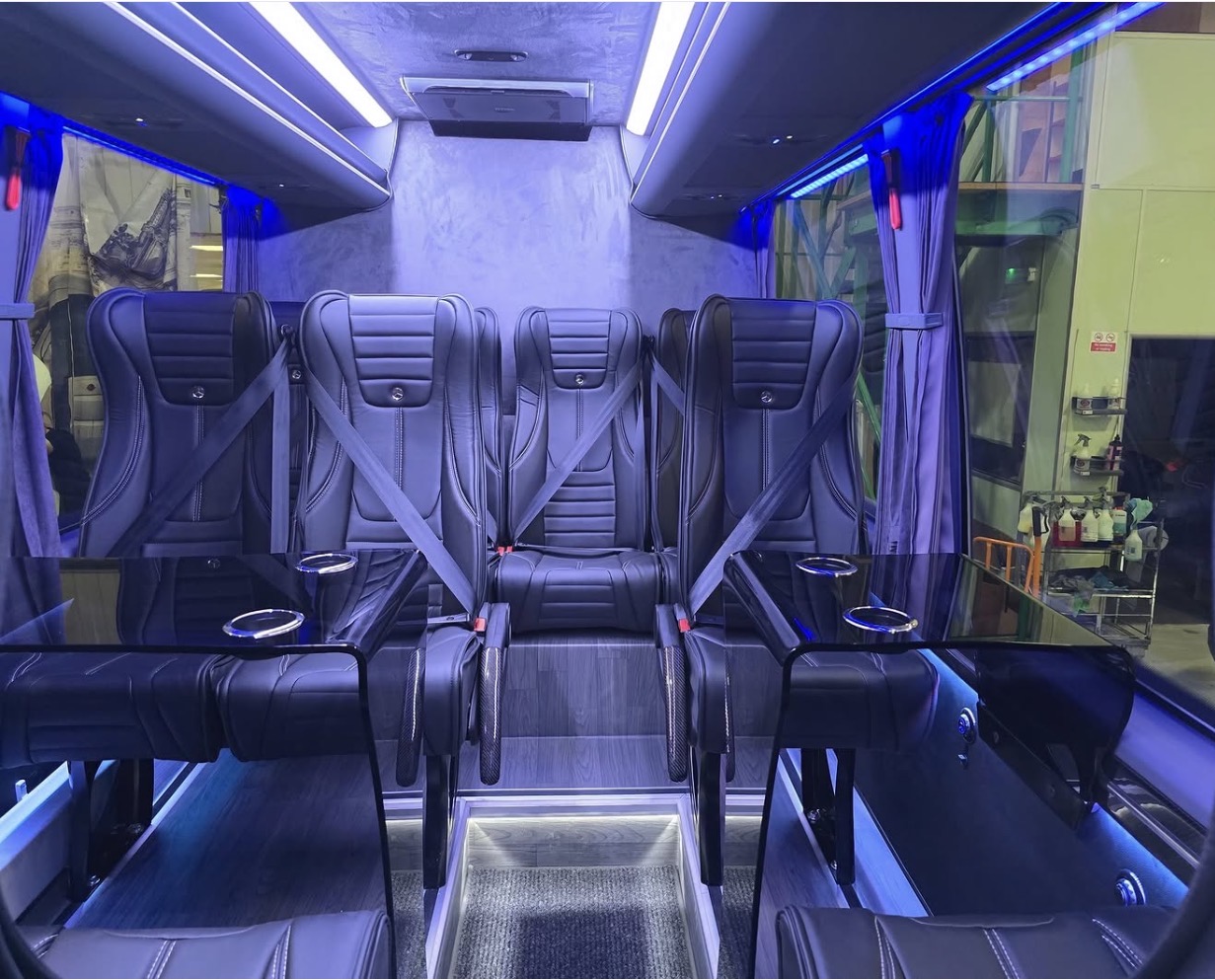 Rear cabin seating with glass tables and cup holders in the executive Sprinter